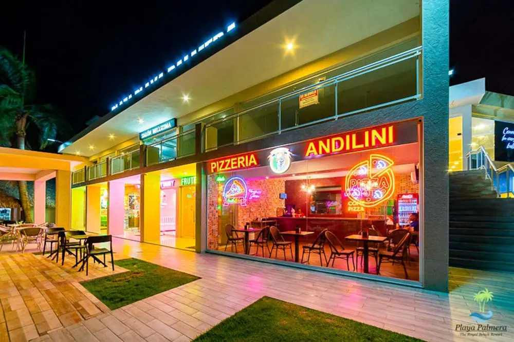 A shot at the entrance of Andilini Pizzeria at Playa Palmera Beach Resort at night 